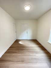 Unfurnished bedroom featuring light wood finished floors and baseboards