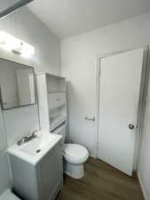Bathroom featuring vanity and dark wood finished floors