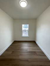 Unfurnished room featuring dark wood finished floors