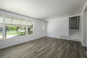 Unfurnished living room featuring wood finished floors