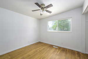 Spare room with light wood-style floors and ceiling fan