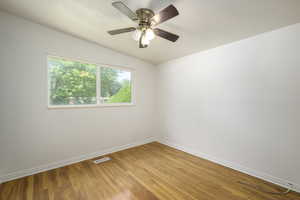 Spare room featuring light wood finished floors and ceiling fan