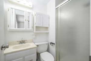 Full bathroom with a shower stall and vanity