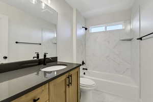 Full bathroom with shower / bathtub combination, vanity, and light marble finish floors
