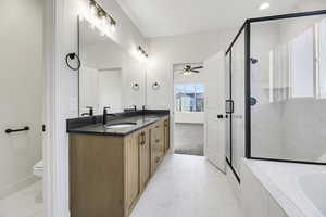 Full bath featuring double vanity, a stall shower, a garden tub, ceiling fan, and recessed lighting