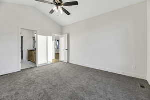 Unfurnished bedroom featuring carpet floors, ceiling fan, high vaulted ceiling, and connected bathroom