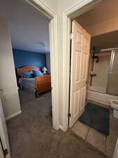 Bedroom featuring carpet and a closet