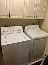 Laundry room featuring washing machine and dryer and cabinet space