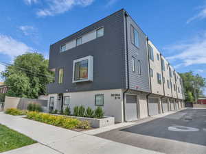 View of building exterior with driveway and an attached garage