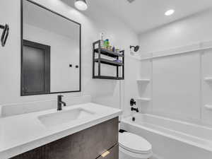 Bathroom featuring tub / shower combination and vanity