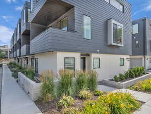 View of home's exterior with stucco siding and a balcony