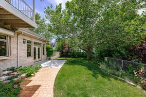 Fenced backyard with french doors, a patio area, and a balcony