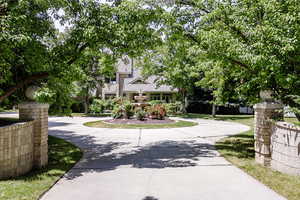 View of front facade featuring curved driveway