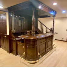 Bar featuring light wood finished floors, recessed lighting, and stairway