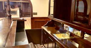 Bar with a wainscoted wall and a sink