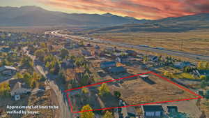 Aerial view at dusk of a mountain view and property boundaries highlighted