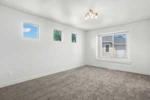 Spare room with carpet floors and baseboards