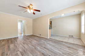 Unfurnished living room featuring light wood-type flooring and ceiling fan