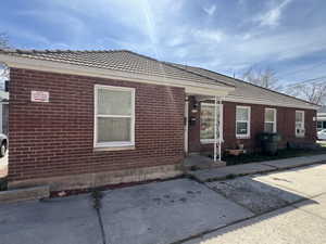 View of front of property featuring a patio and a tiled roof
