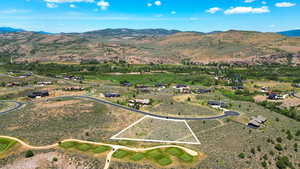 Aerial view of property and surrounding area with mountains