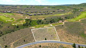 Aerial overview of property's location featuring a local golf course and property parcel outlined
