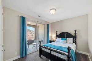 Carpeted bedroom with access to outside and baseboards