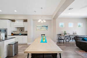 Dining space featuring a chandelier, light wood-type flooring, and recessed lighting