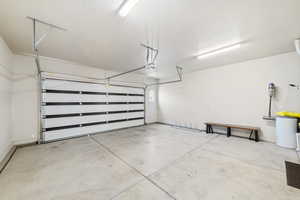 Garage featuring baseboards and a garage door opener