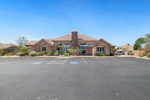 View of property featuring uncovered parking