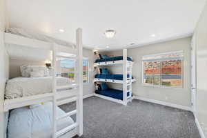 Carpeted bedroom with baseboards and recessed lighting