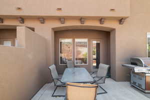 View of patio featuring grilling area and outdoor dining area
