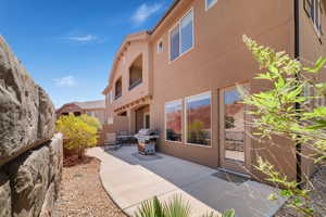 Back of property with a patio area and stucco siding