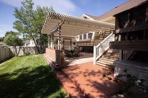 Fenced backyard with a pergola and a patio area
