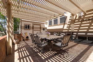 View of patio / terrace with outdoor dining space and a pergola