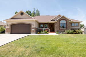 Ranch-style home with concrete driveway, stucco siding, a garage, a porch, and a front lawn