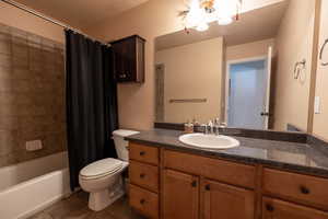 Bathroom featuring vanity, tile patterned floors, and shower / bath combo