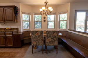 Dining room featuring a chandelier and light tile patterned flooring