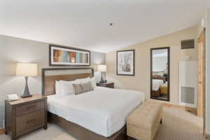 Bedroom featuring vaulted ceiling and light wood-type flooring