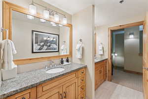 Bathroom with vanity and tile patterned floors