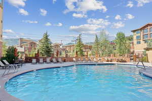 Community pool with a patio