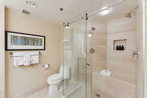 Bathroom featuring a stall shower and tile patterned floors