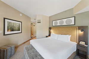 Carpeted bedroom featuring baseboards