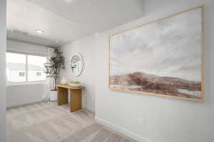 Empty room featuring a textured ceiling and carpet floors