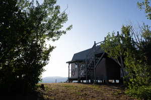 View of side of home featuring a metal roof