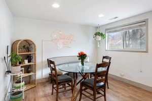 Dining area featuring light wood style finished floors, natural light and recessed lighting