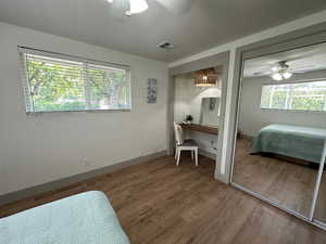 Bedroom featuring built in desk nook, closet, gorgeous views, natural light and ceiling fan