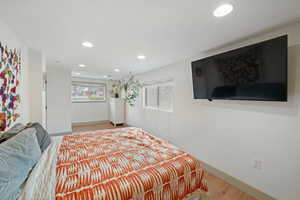 Primary bedroom with natural light, closet and recessed lighting