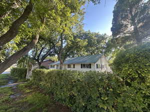 Gorgeous, mature trees offer shade and privacy on this amazing corner lot