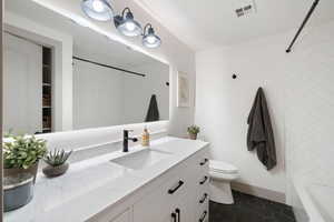 Bathroom with vanity, tile flooring, and bathtub/shower combination