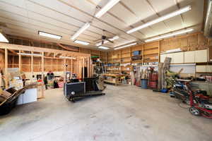 Large, detached garage with a workshop area, bathroom and ceiling fan
